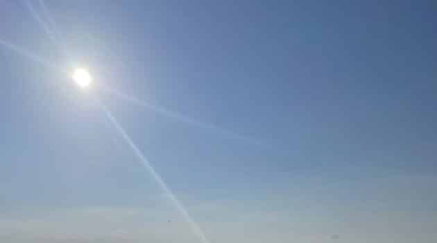 Rays come from the sun in a blue sky