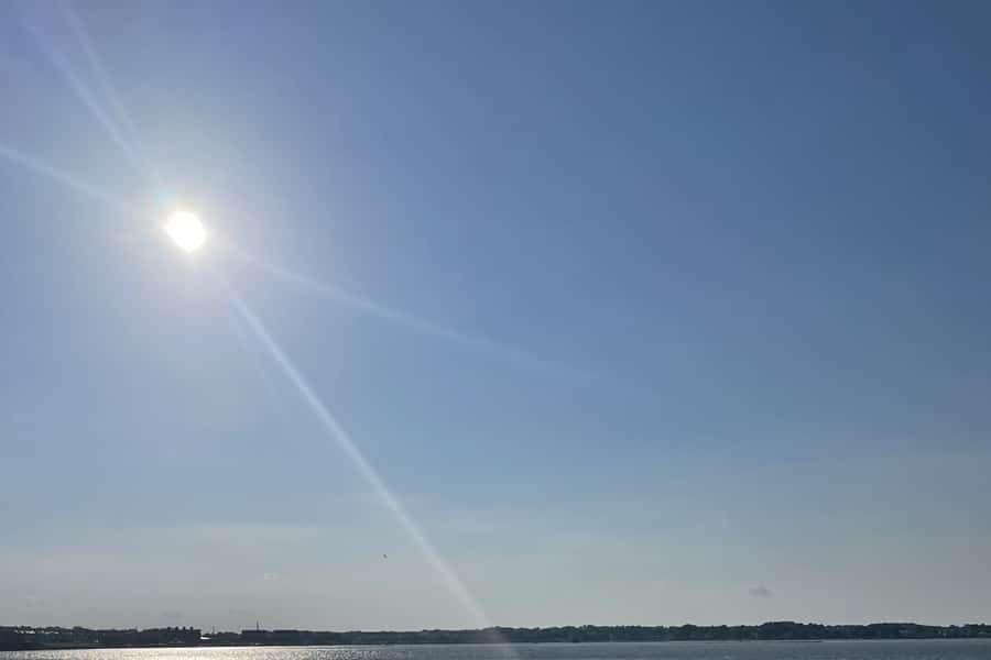 Rays come from the sun in a blue sky