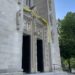 Yellow and white cloth hangs over the doors of Cathedral of Mary Our Queen in honor of the papal election