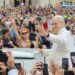 A smiling Pope Leo waves to a crowd in St. Peter's Square